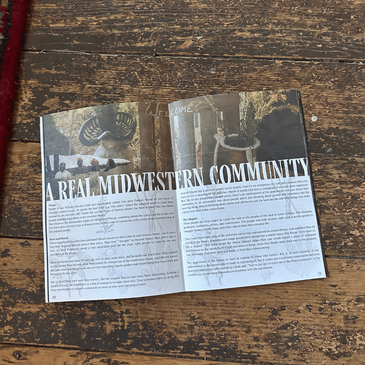 Open magazine with an article titled "A REAL MIDWESTERN COMMUNITY" on a wooden surface. The article discusses the community and history of Duncan Manor in Central Illinois, and features images of plants and a group of people.