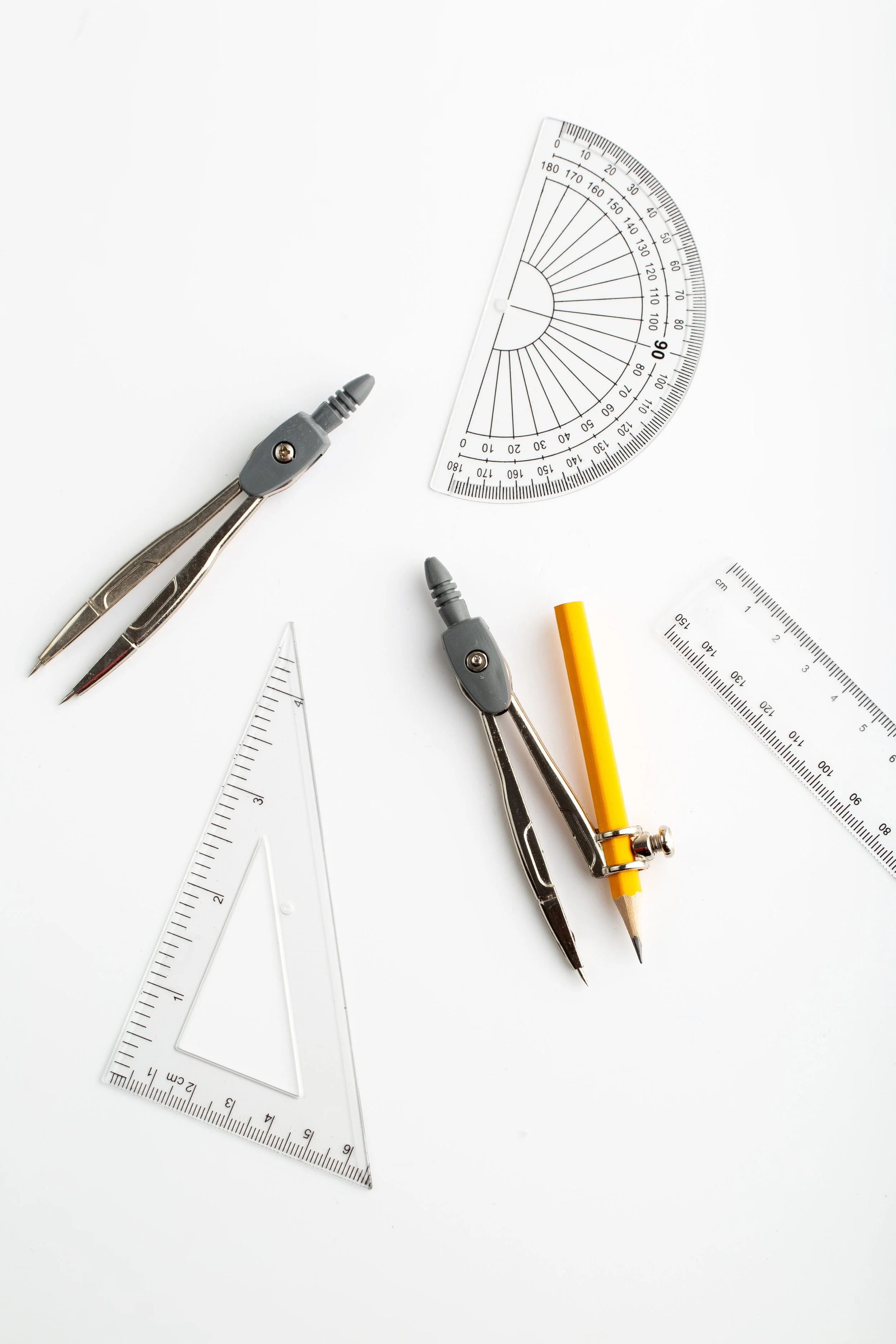 Angles, rulers, and drafting tools on a white background.