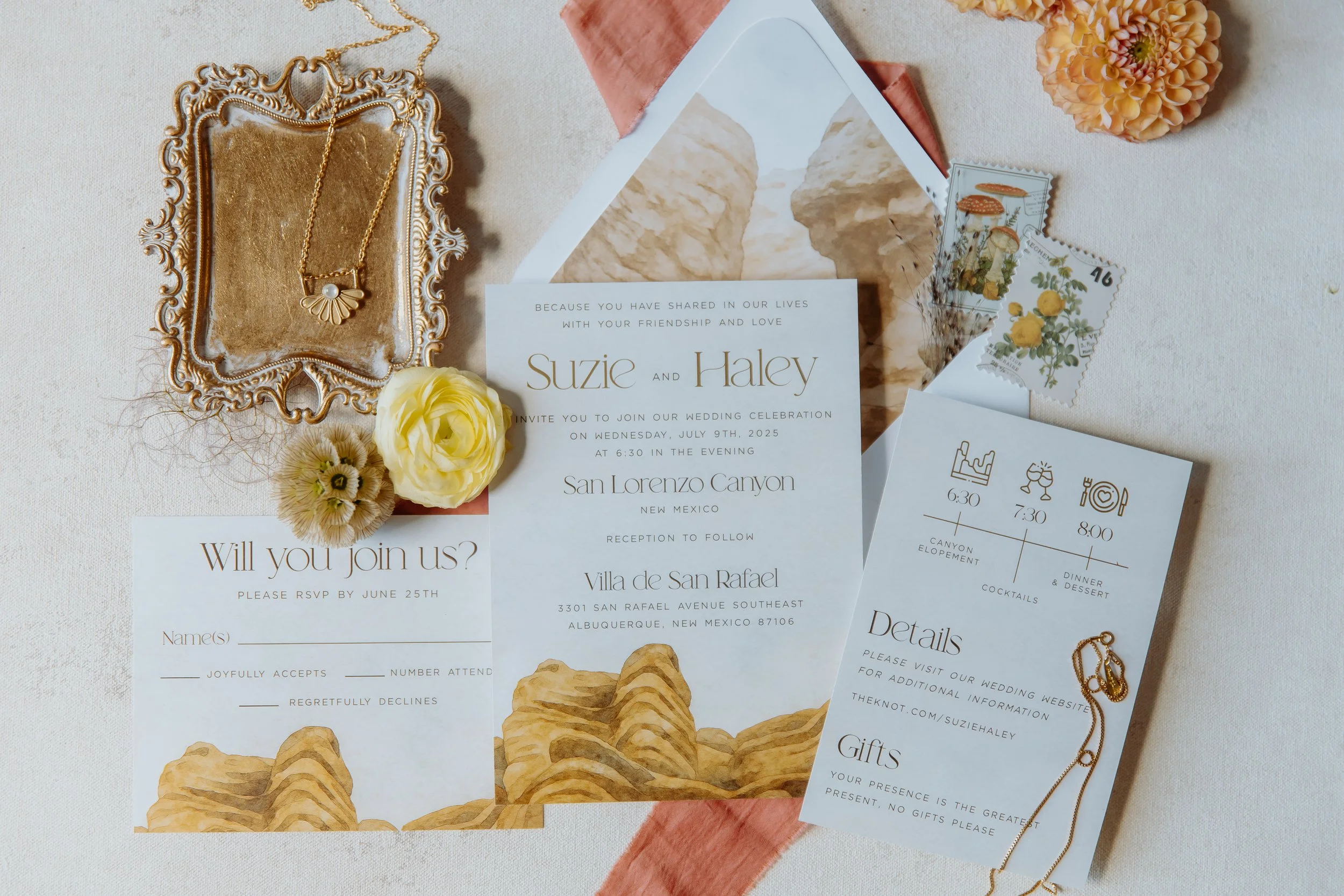 Wedding invitation suite, including invitation card, RSVP card, details card, and envelope, displayed on a light surface with flowers, jewelry, and stamps, for a wedding at San Lorenzo Canyon, New Mexico on July 9, 2025.
