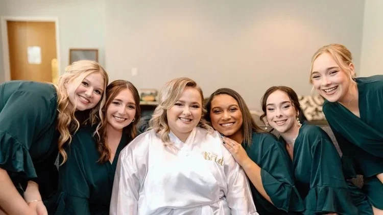 Bride in a satin white robe with 