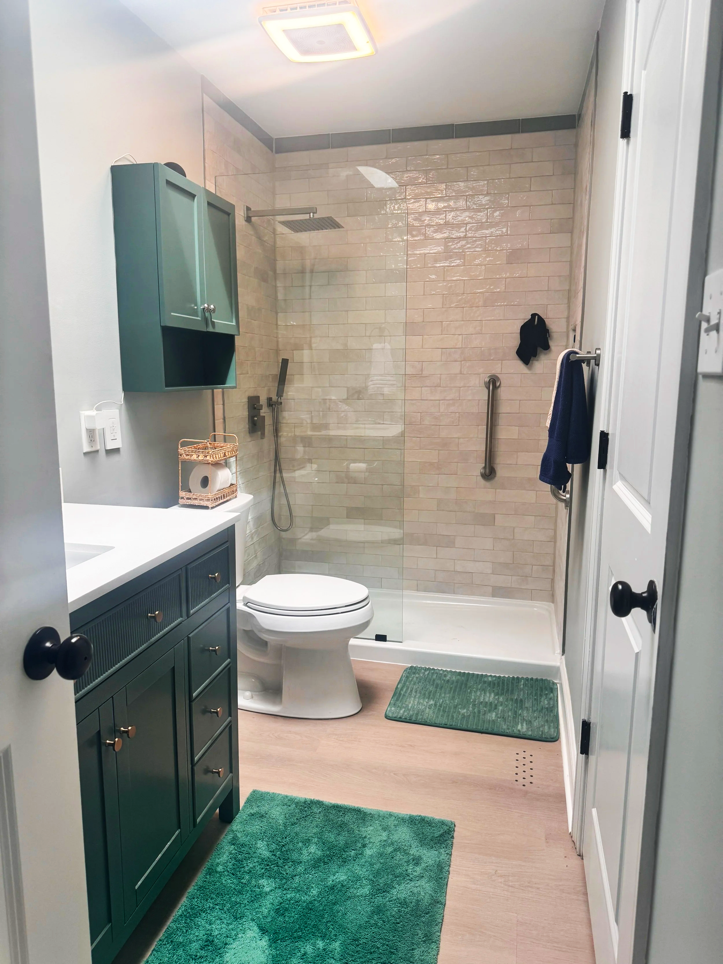 newly renovated tile bathroom and wood flooring