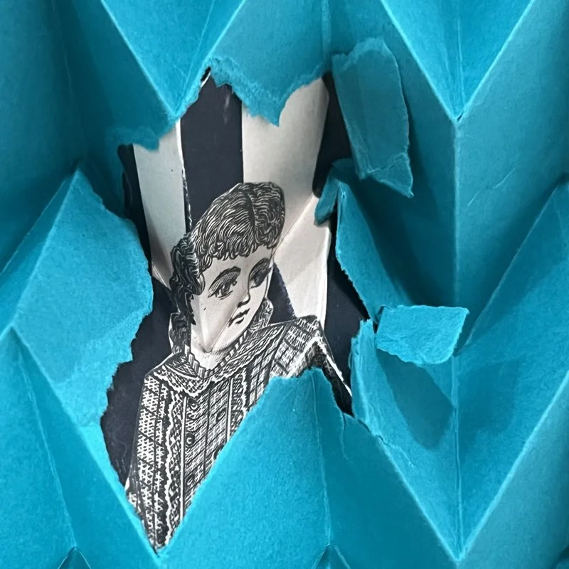 A black and white drawing of a young girl, wearing a patterned shirt, seen through a torn opening in blue paper.