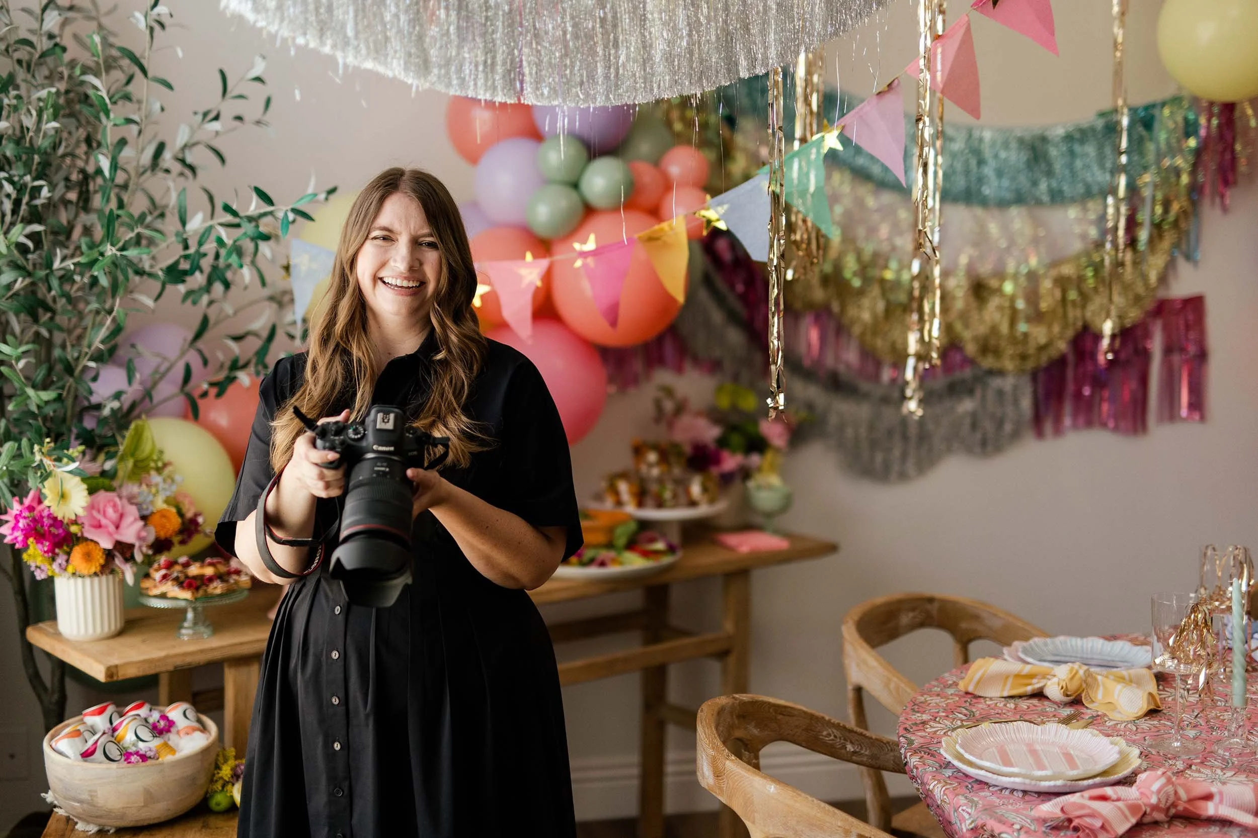 flip-target Los Angeles event photographer, Alyssa Hunter, holding a Canon camera while at a birthday celebration