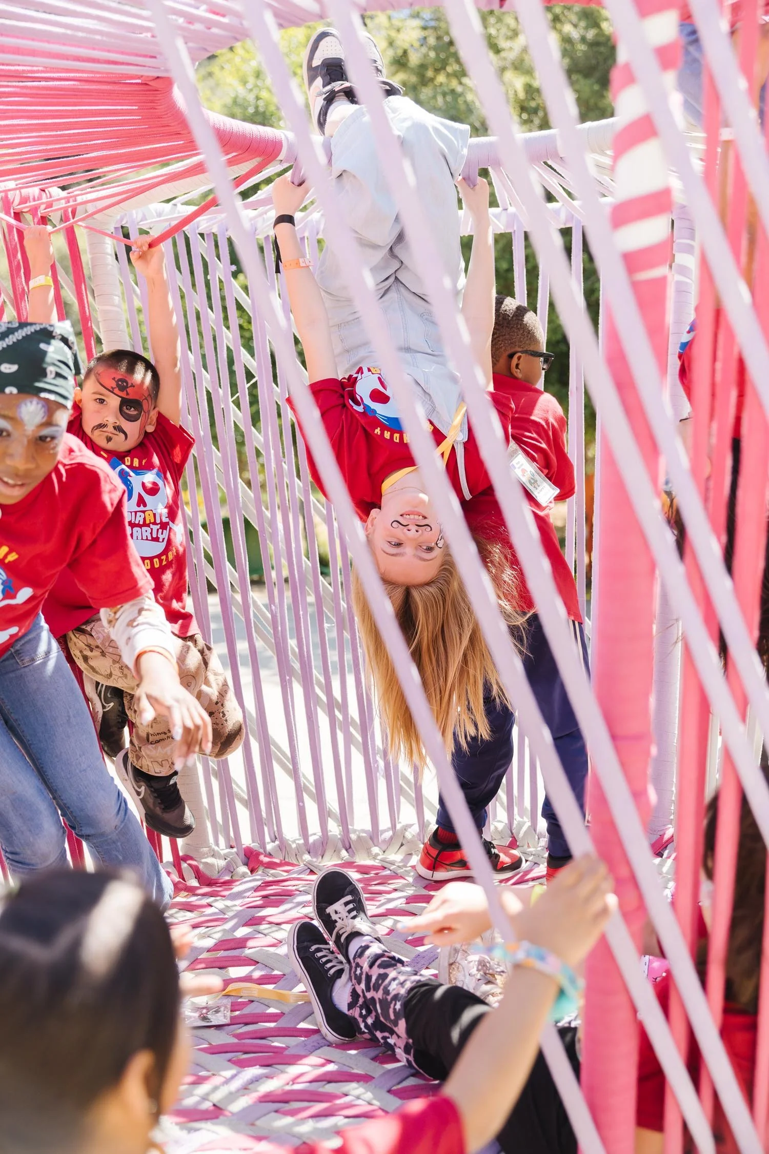Kids playing outside on a fun jungle gym