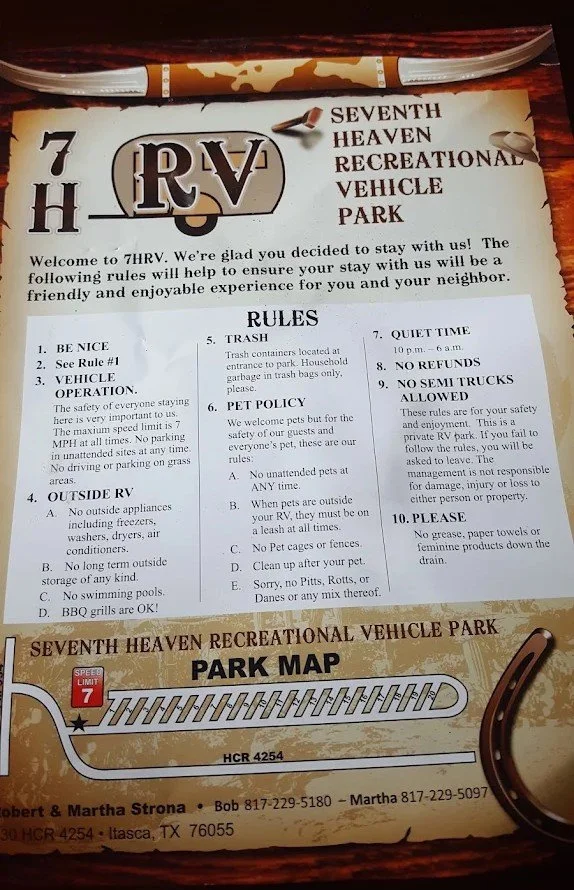 Informational sign and park map at Seventh Heaven Recreational Vehicle Park, with rules and a horse-shoe shaped decorative element.