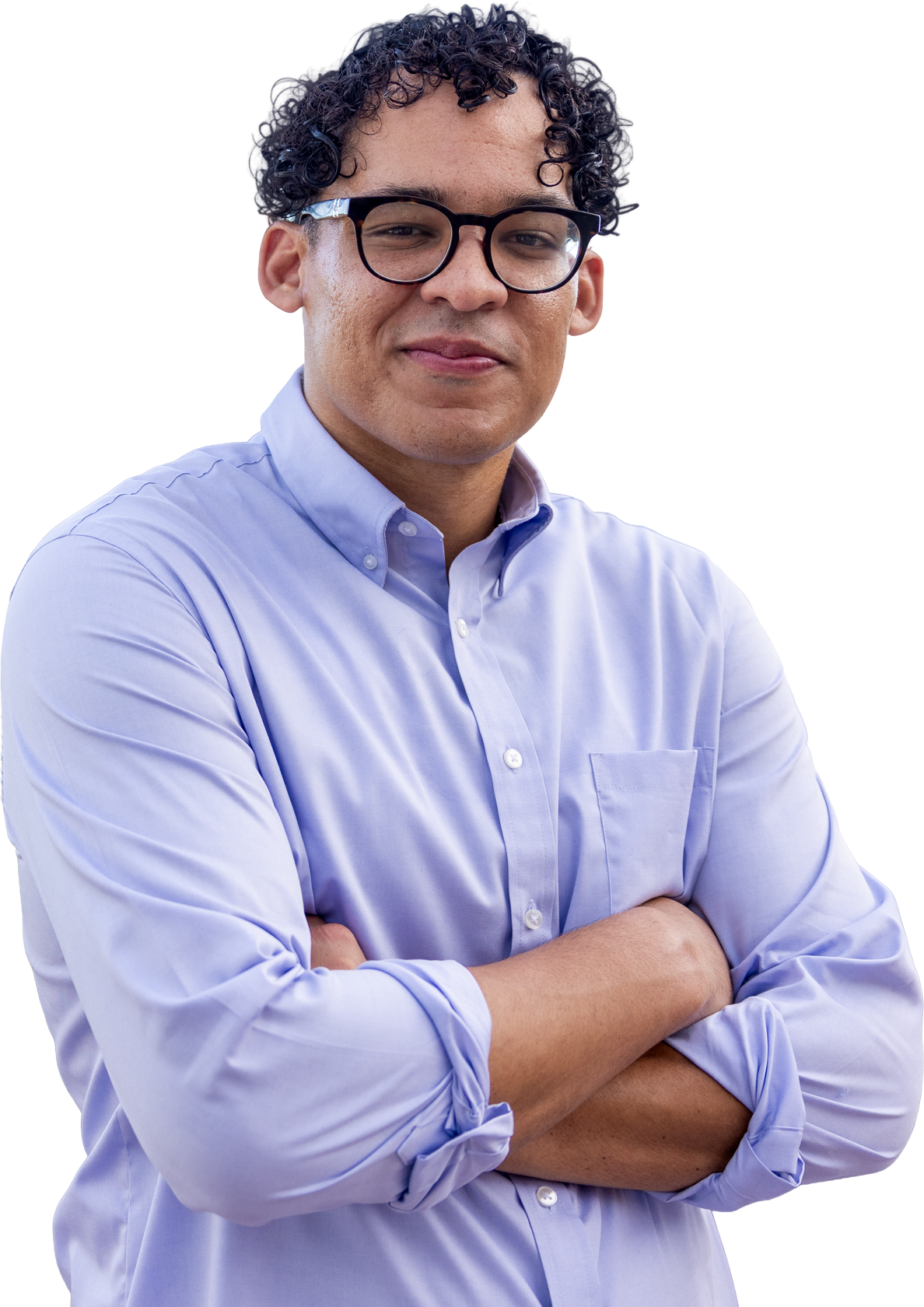 Nik Dean with curly dark hair, glasses, and light skin wearing a light purple button-down shirt with arms crossed.