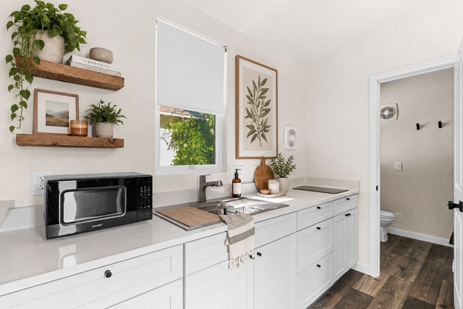 Forever 32′ kitchen featuring quartz countertops, light gray soft-close cabinets, black cabinet hardware, and an induction cooktop, with a window above the sink.