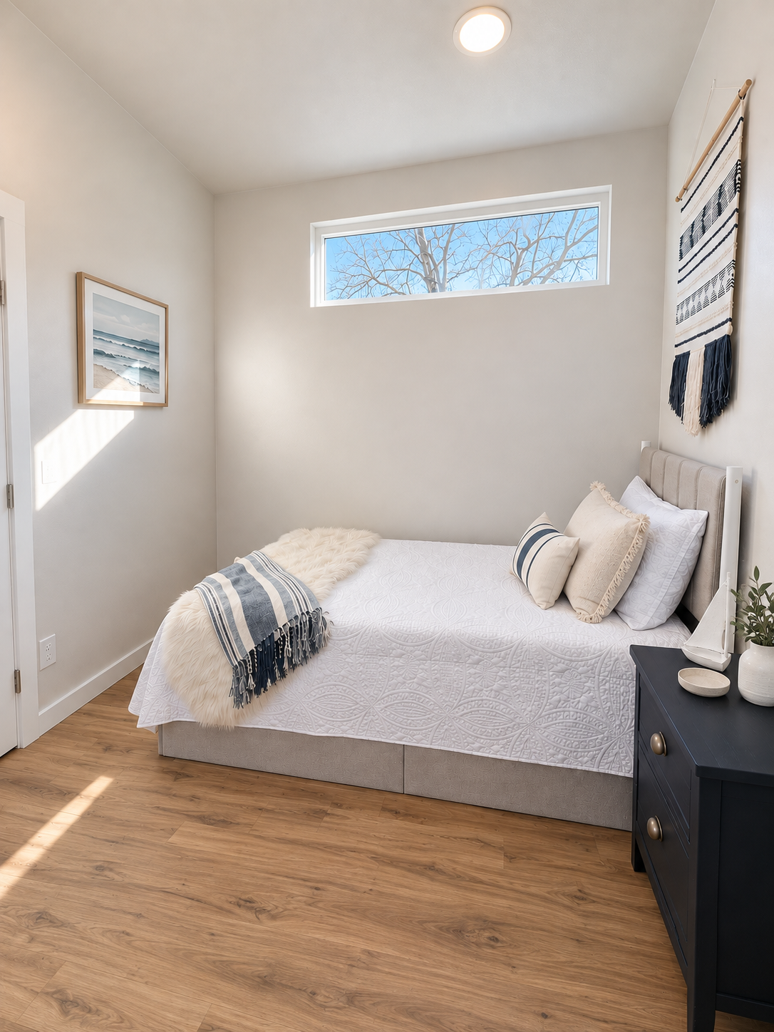 Forever 40′ 2B main-floor bedroom featuring Pergo Outlast flooring, finished drywall walls, and space for bedside storage, with no loft or ladder needed.