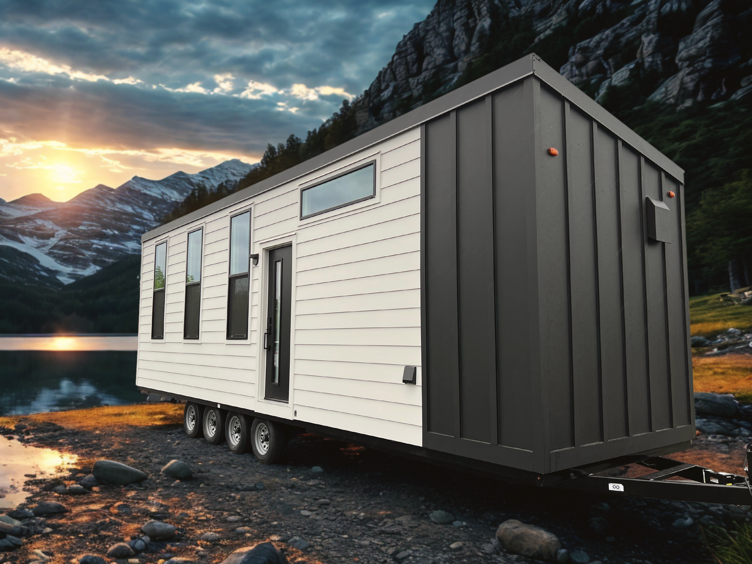 Forever 32′ tiny home on wheels featuring fiber cement lap siding, a contrasting dark accent wall, and a standing seam metal roof.