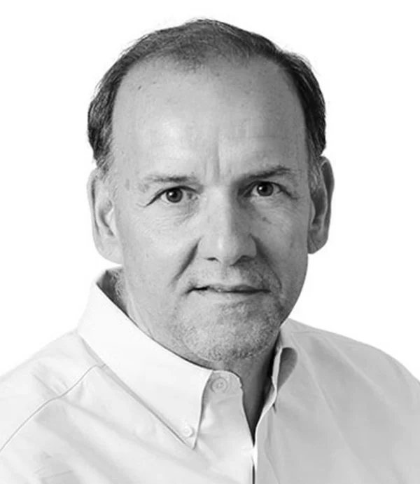 Portrait of a man in a white shirt, facing forward, black and white photo.