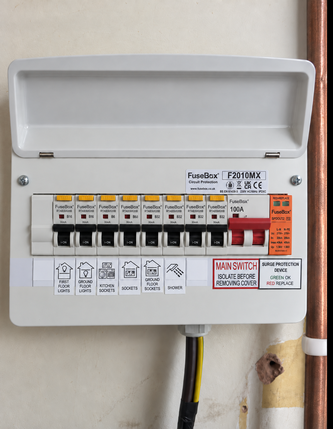 Electrical fuse box mounted on a wall with labels indicating its function and safety instructions.