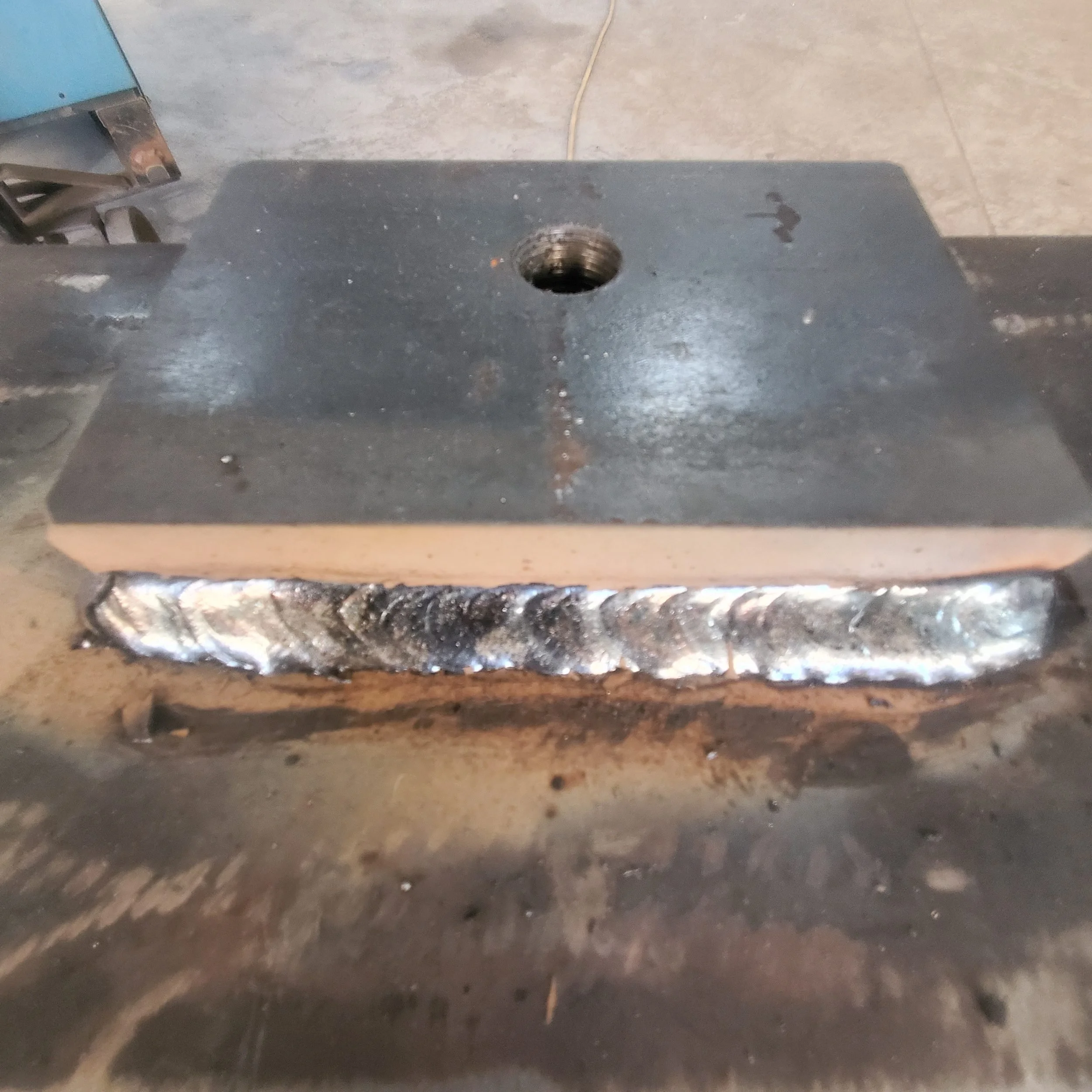 Weld detail on the one-inch steel plate of an industrial winch support base