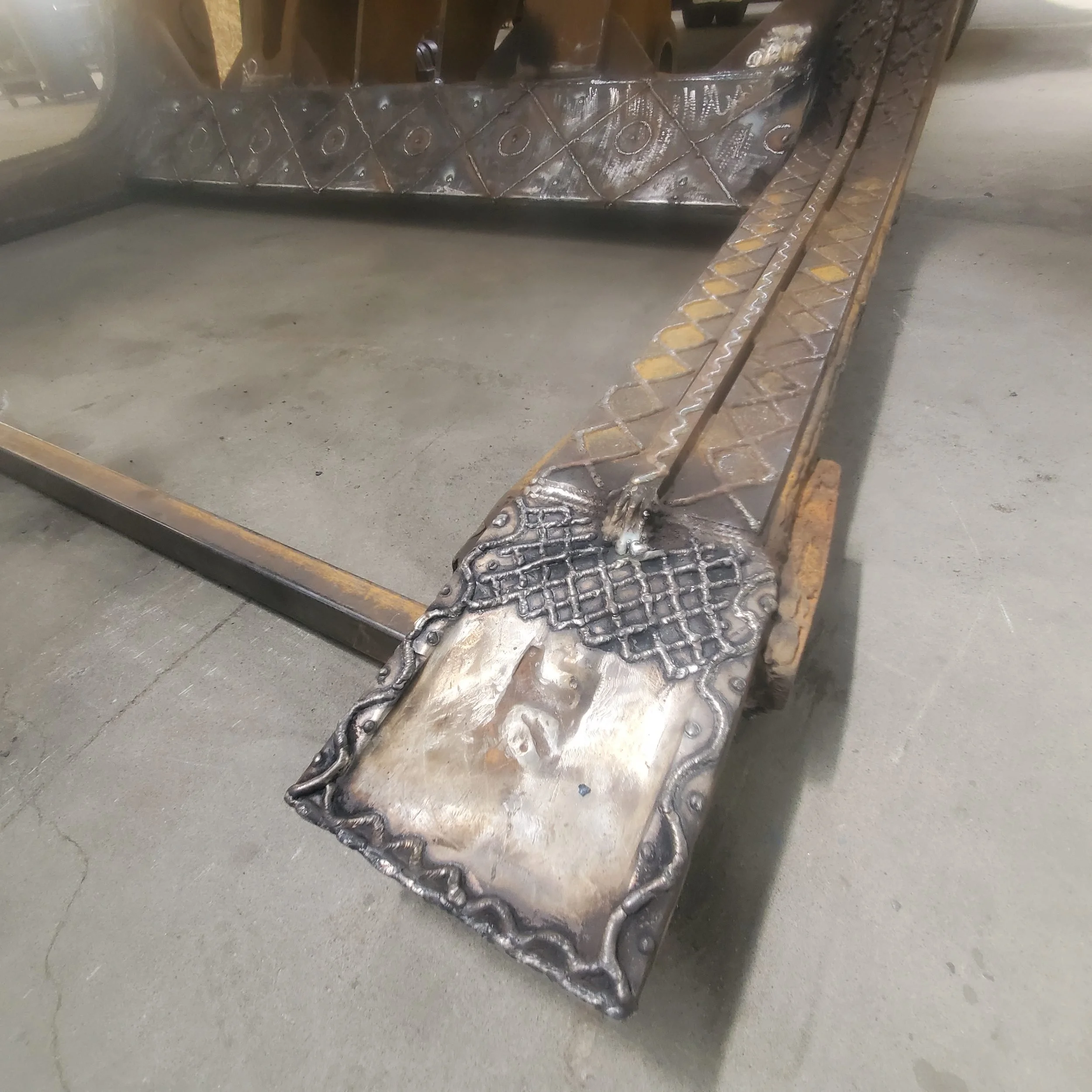 Worn industrial component restored with crosshatch hardfacing weld beads for wear resistance