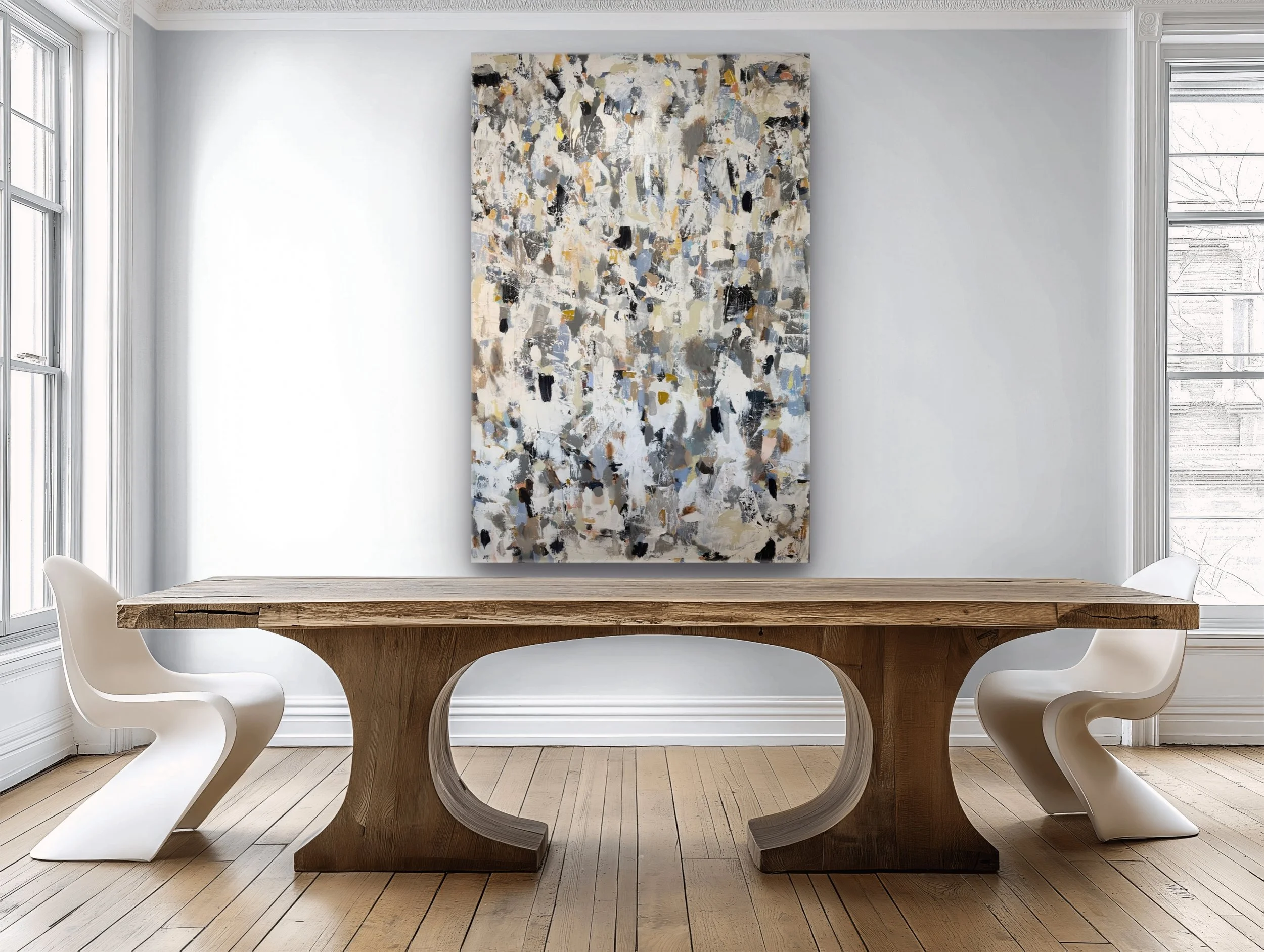 A modern dining room with a wooden table and white chairs, abstract painting on a white wall, and large windows with curtains.