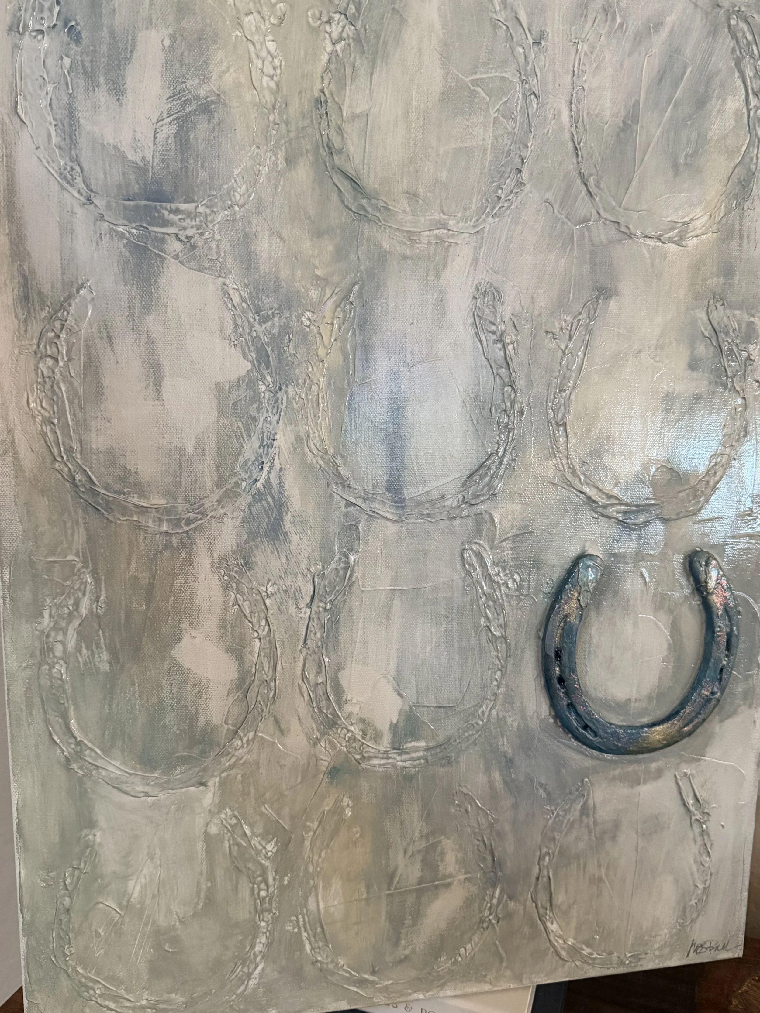 Silver textured abstract artwork with large oval shapes and the word 'LOVE' written, featuring a horseshoe shape at the bottom right corner.
