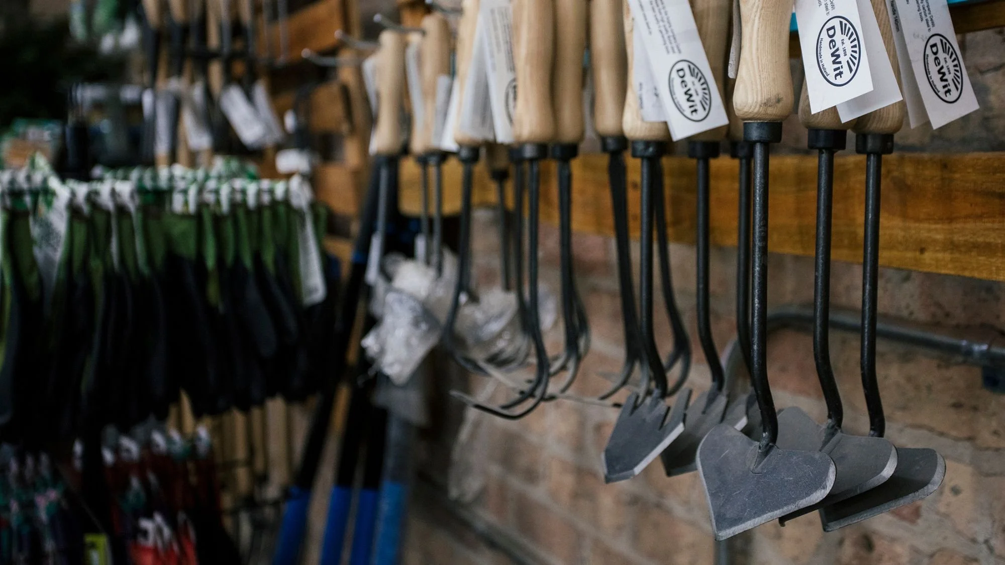 Hammers hanging on a wooden display rack in tallgrass garden formerly christy webber farm & garden