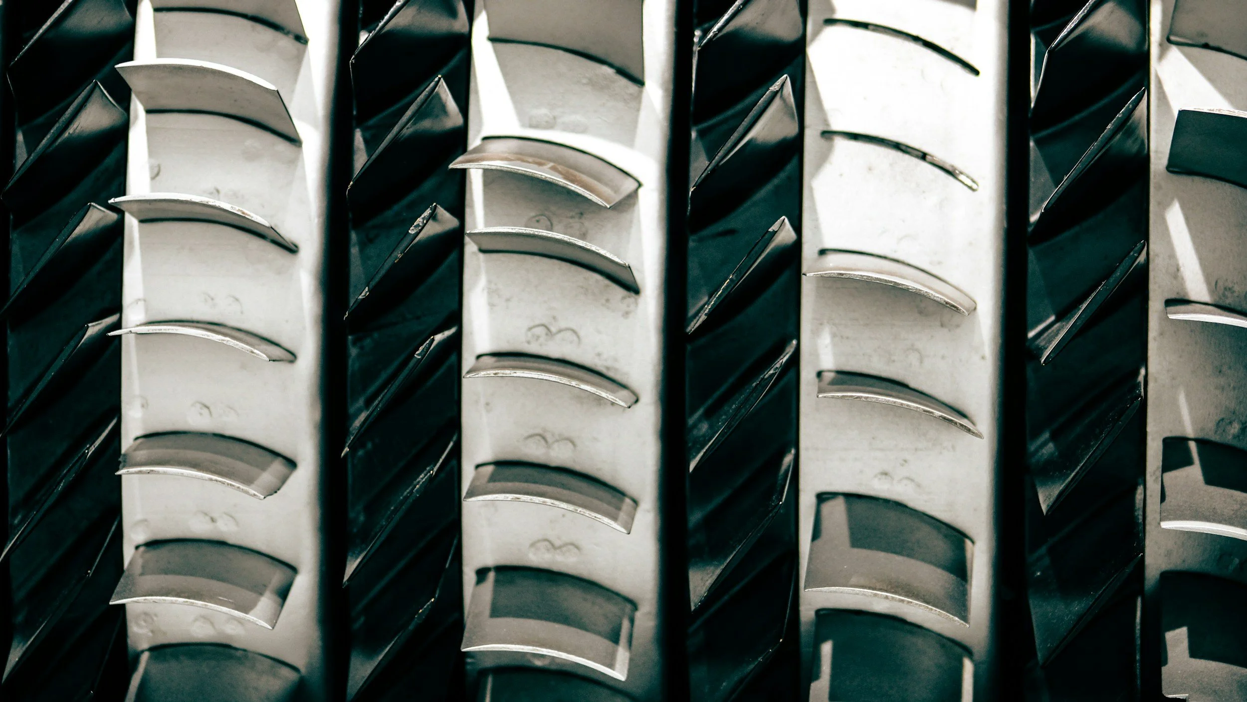 Close-up of tire treads with black and white rubber sections.