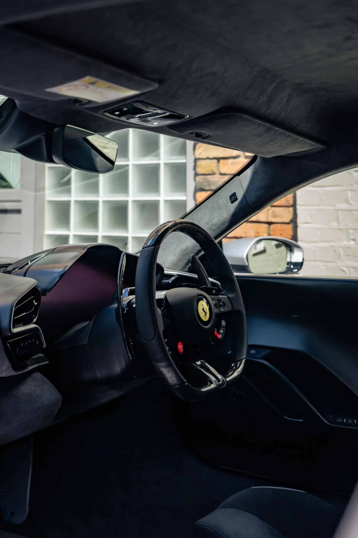 Ferrari 296 Speciale in Argento Nürburgring — Steering wheel viewed from the passenger side — AKC Asset Management.