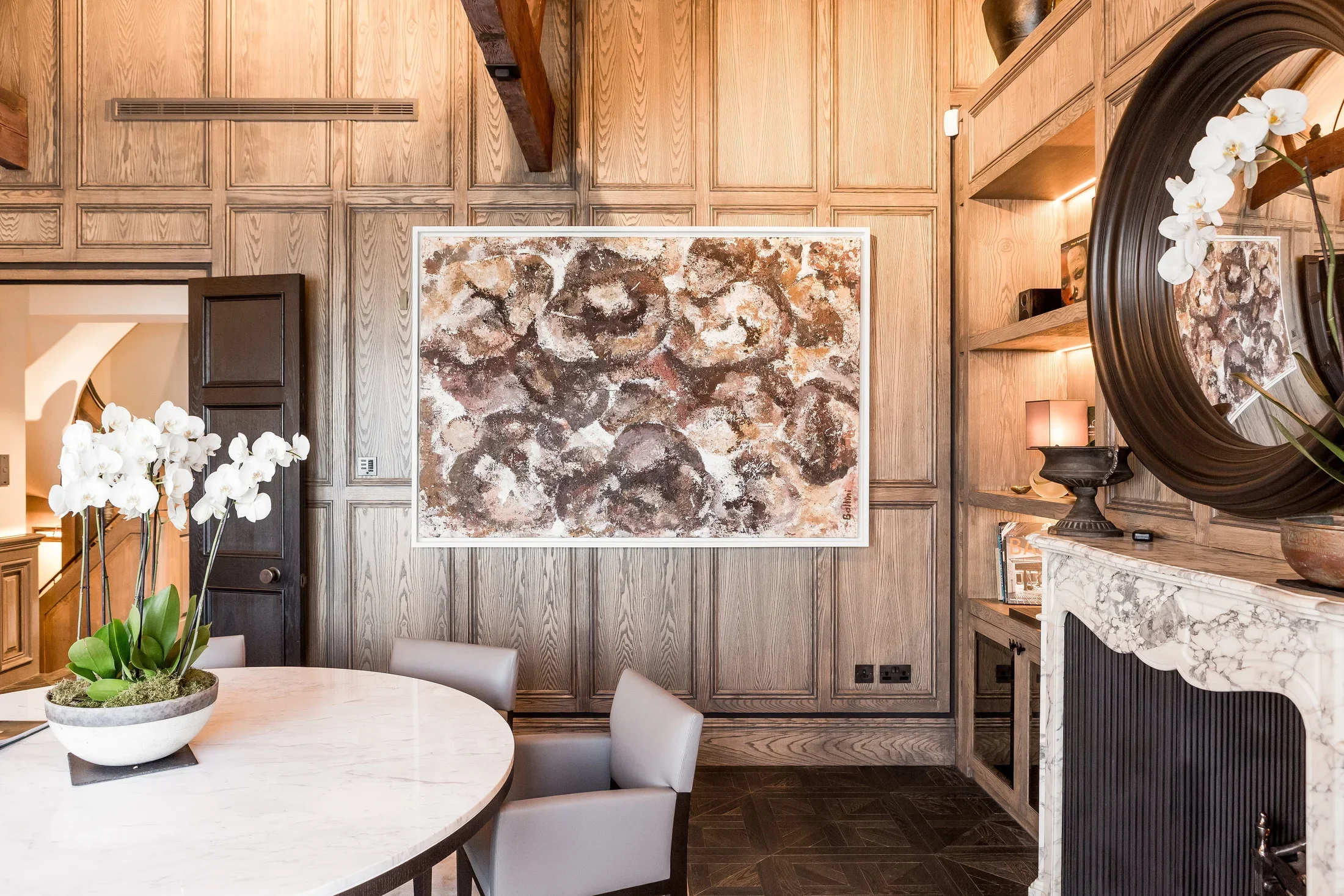 Large abstract artwork displayed in a wood-panelled room — AKC Asset Management art advisory and collection management.