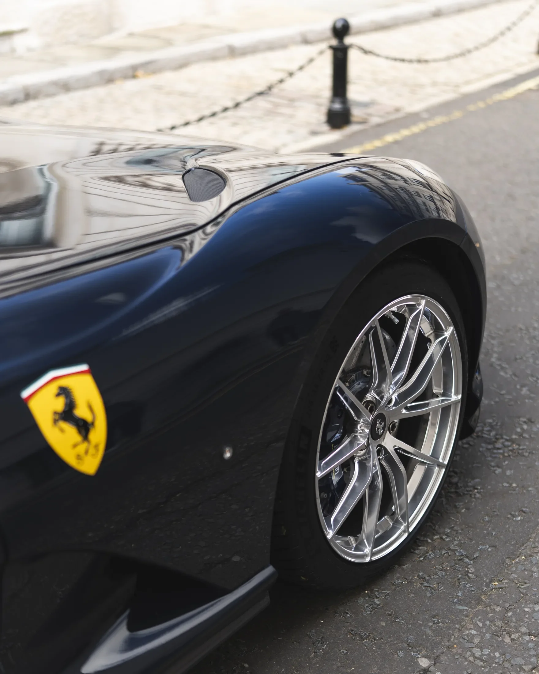 Ferrari 812 Superfast in Blue Pozzi — Front wheel and yellow wing badge — AKC Asset Management.