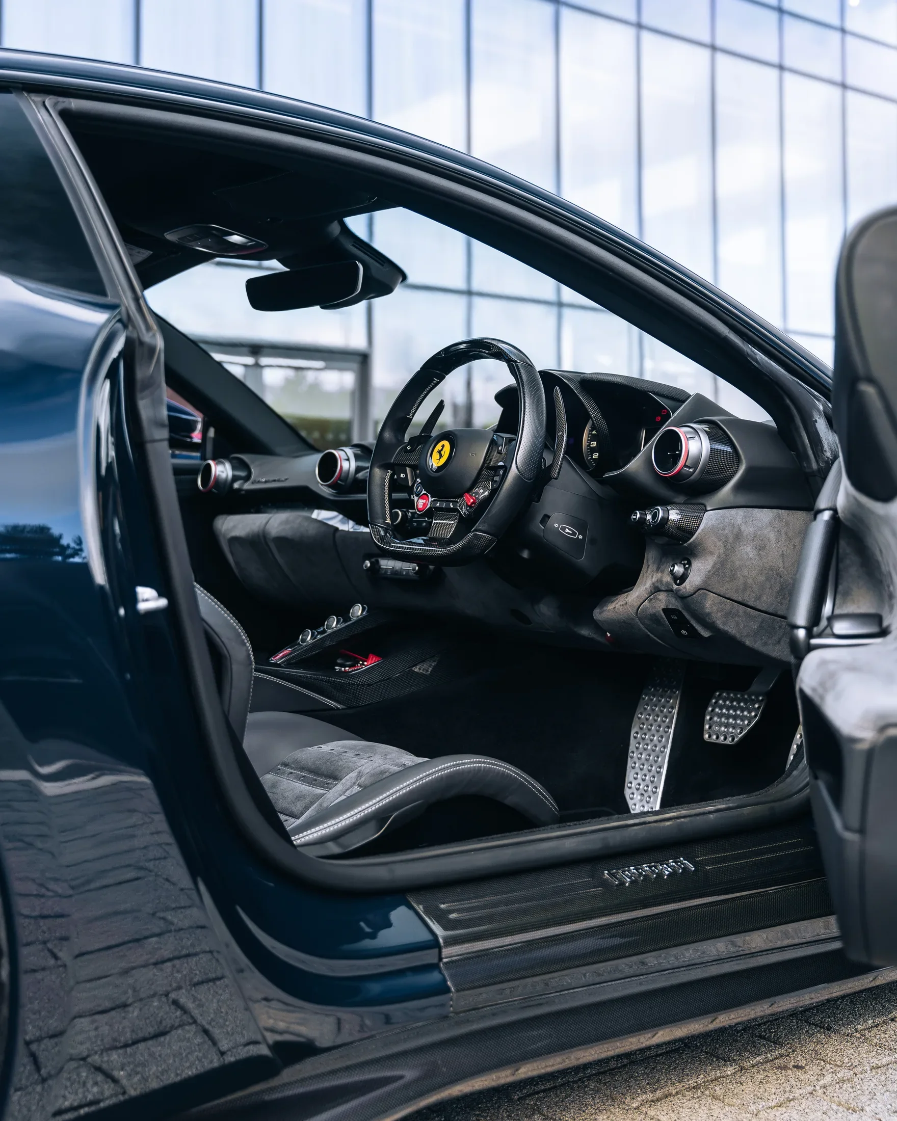 Ferrari 812 Superfast in Blue Pozzi — Cockpit viewed through the open driver’s door — AKC Asset Management.