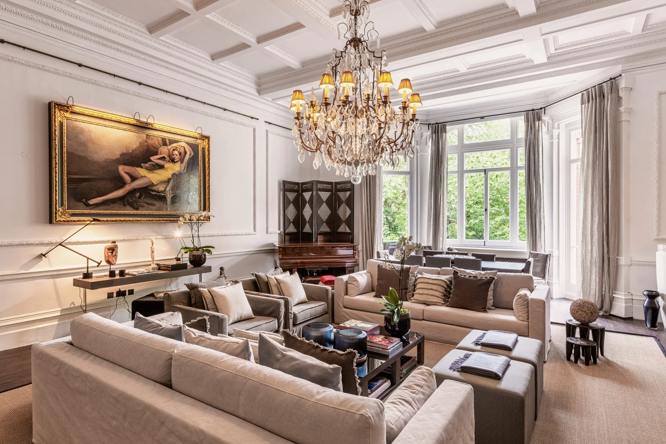 Formal drawing room with chandeliers and upholstered seating — AKC Asset Management real estate, part of AKC Group.