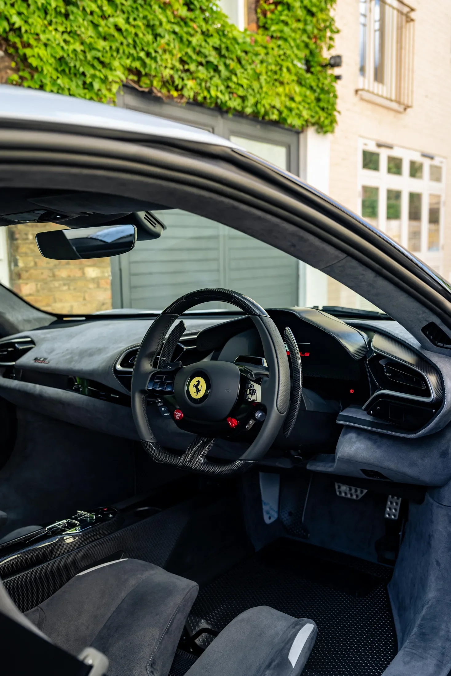 Ferrari 296 Speciale in Argento Nürburgring — Steering wheel and dark upholstered cockpit — AKC Asset Management.