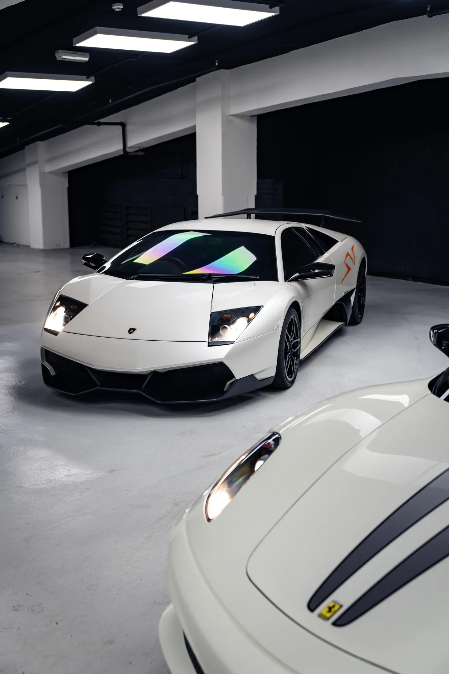 White Lamborghini in a private garage — AKC Asset Management.