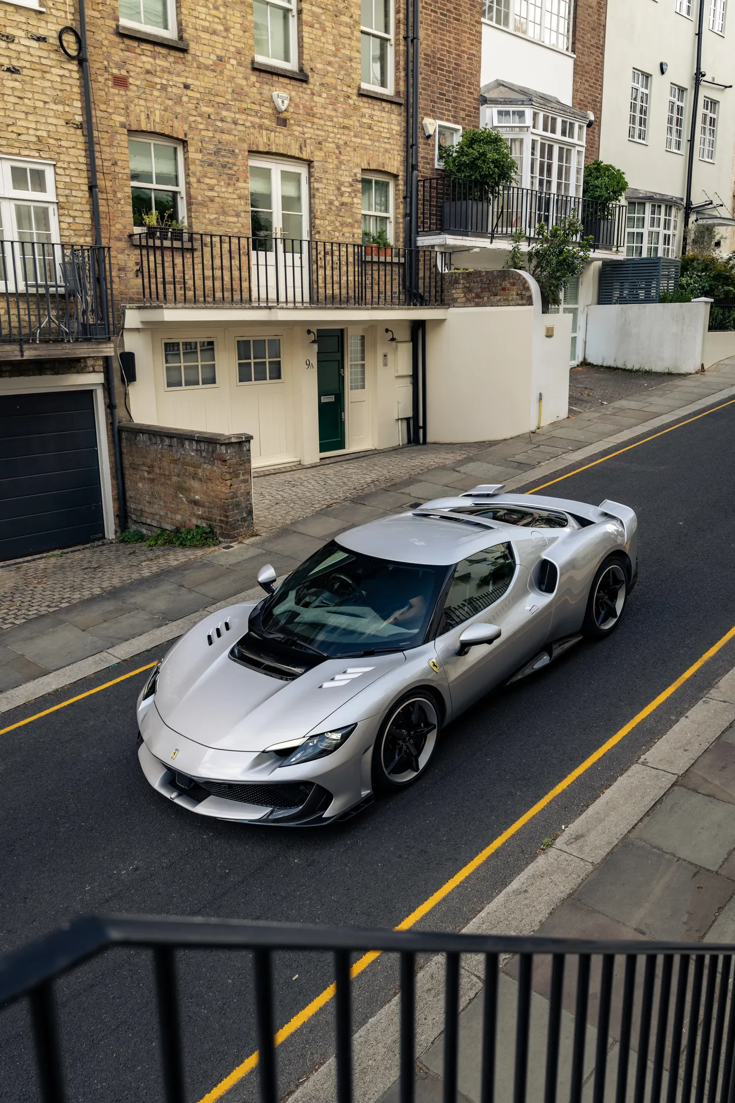 Ferrari 296 Speciale in Argento Nürburgring — Elevated view parked on a street — AKC Asset Management.