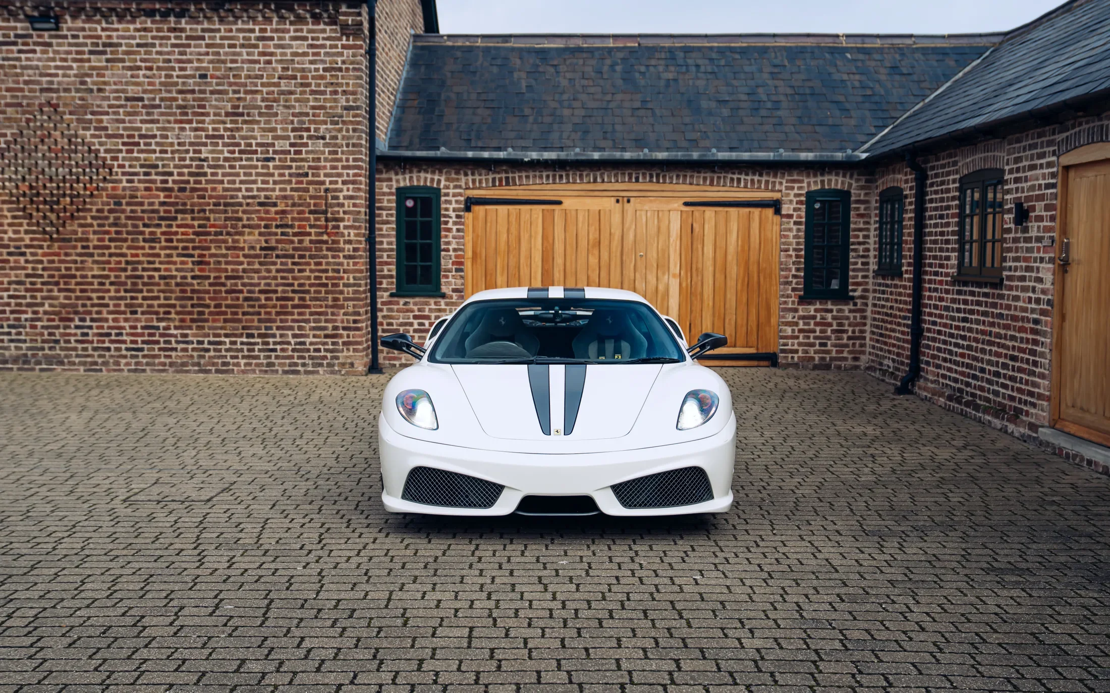 Ferrari 430 Scuderia in Bianco Avus — Front bumper and twin bonnet stripes — AKC Asset Management.