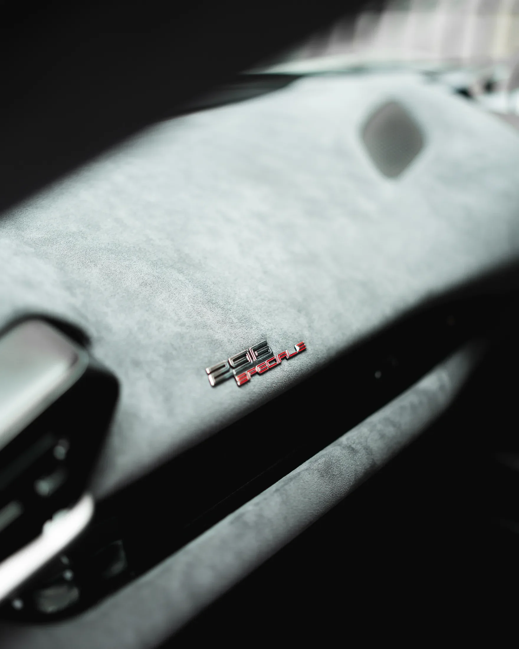 Ferrari 296 Speciale in Argento Nürburgring — Dashboard material and badge detail — AKC Asset Management.