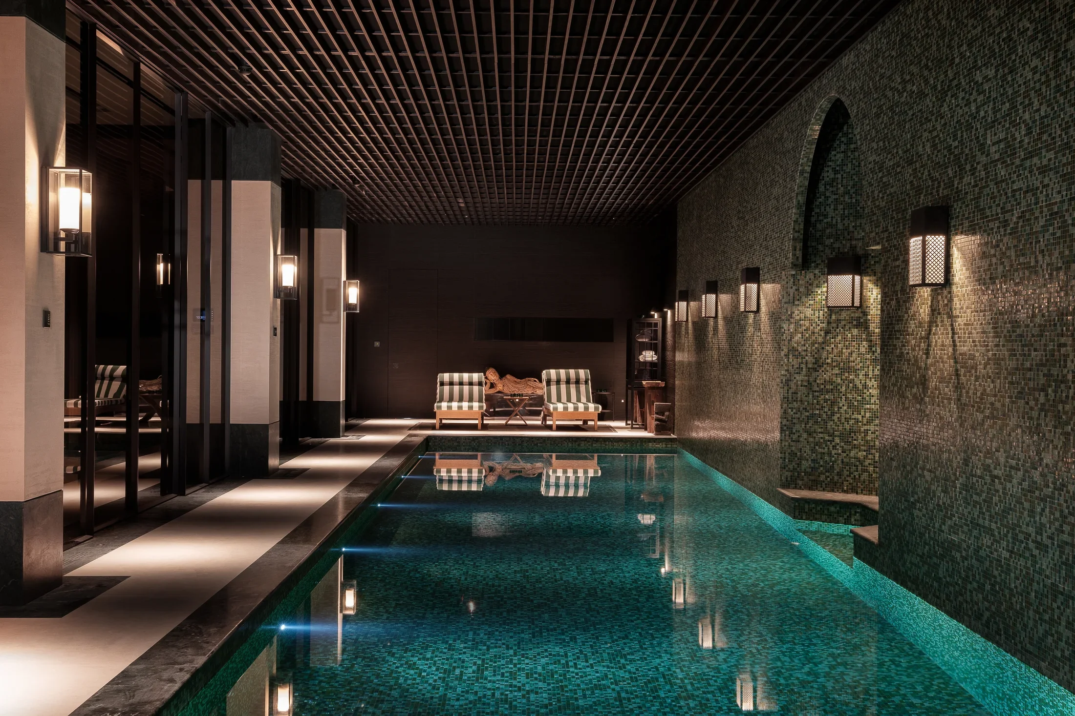 Indoor swimming pool beneath a timber ceiling — AKC Asset Management real estate, part of AKC Group.