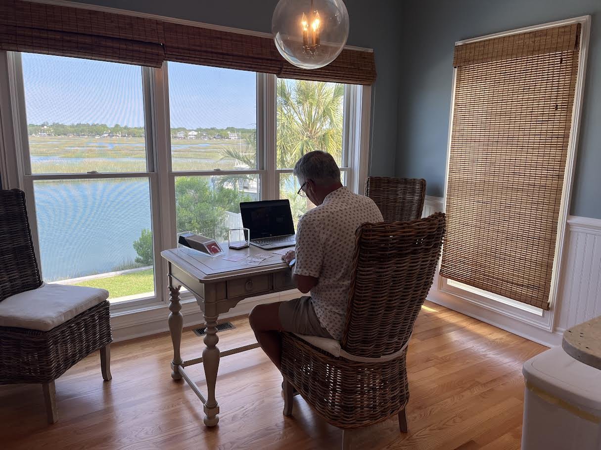 David Krites working at a table while writing and developing new ideas.