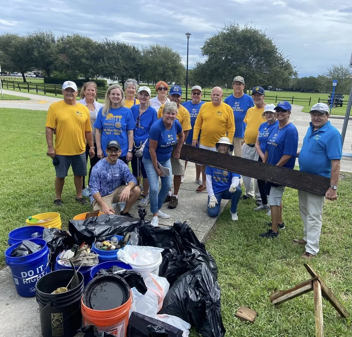 Sunrise Rotary Vero Beach volunteers with bags and buckets of debris collected during a community cleanup.