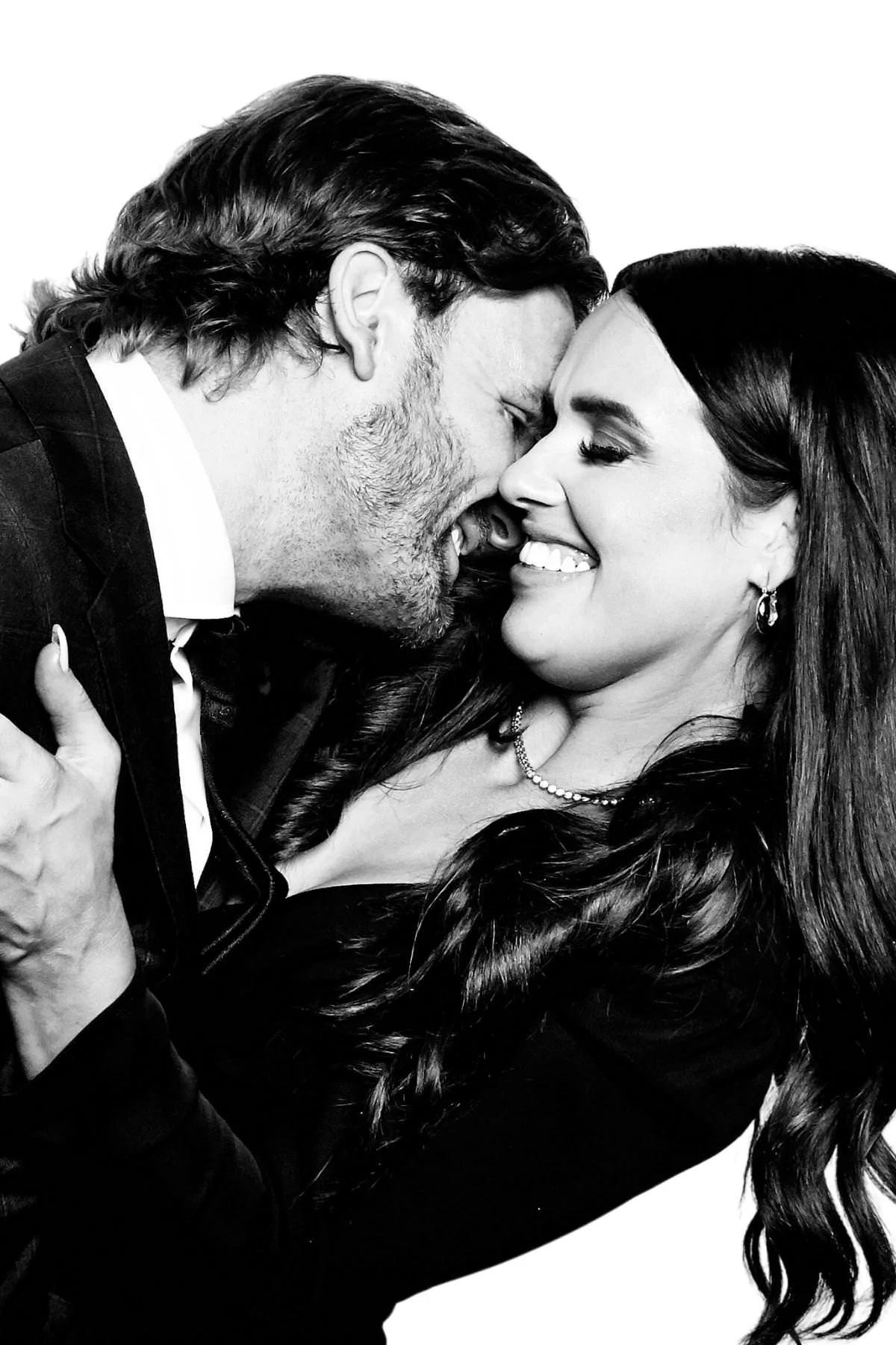 Couple nuzzling and smiling in a close black and white portrait at a Lake Louise wedding