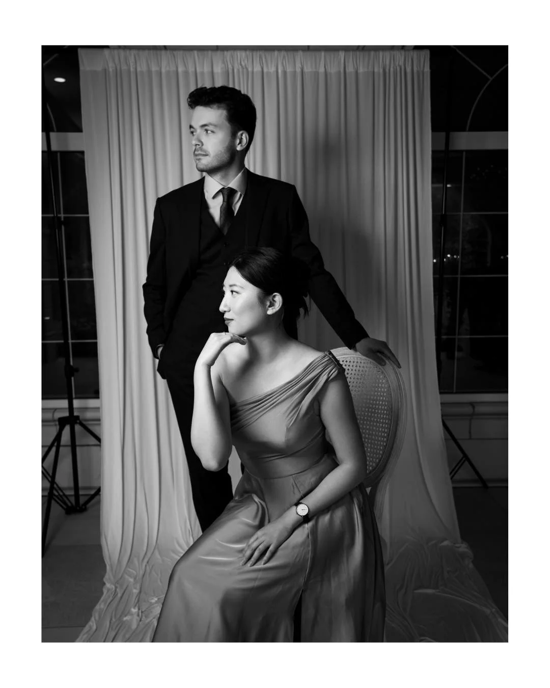 wedding guests posed for a portrait in front of a draped backdrop at archway manor in Alberta.