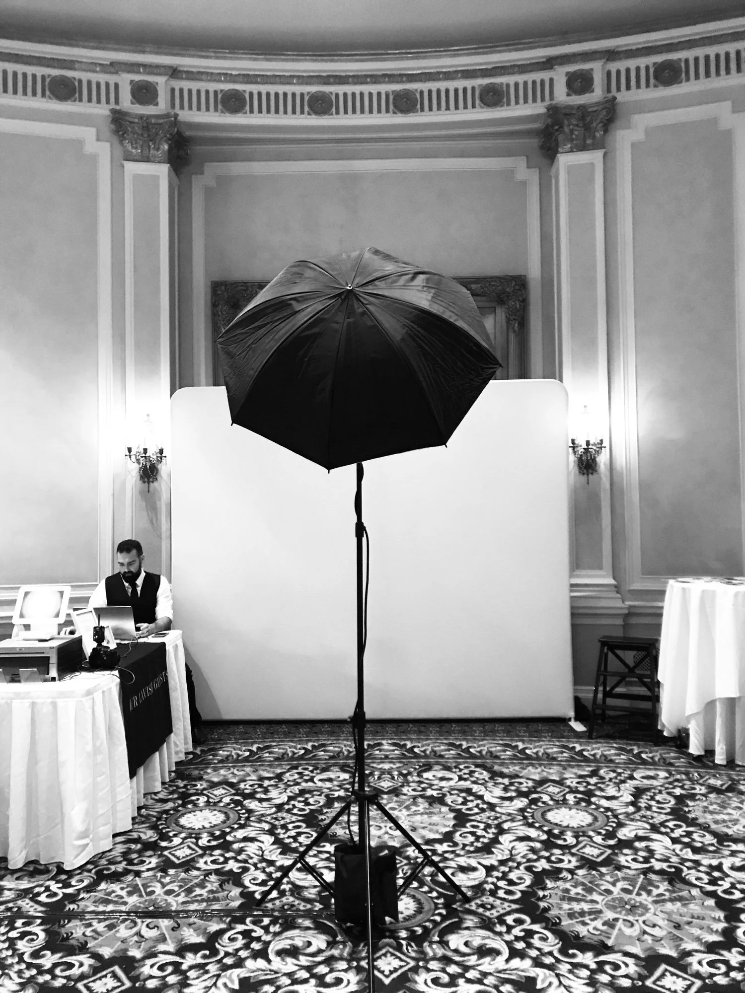 Wedding portrait station in the Fairmont Palliser ballroom in Calgary, with a white backdrop, umbrella light and print station