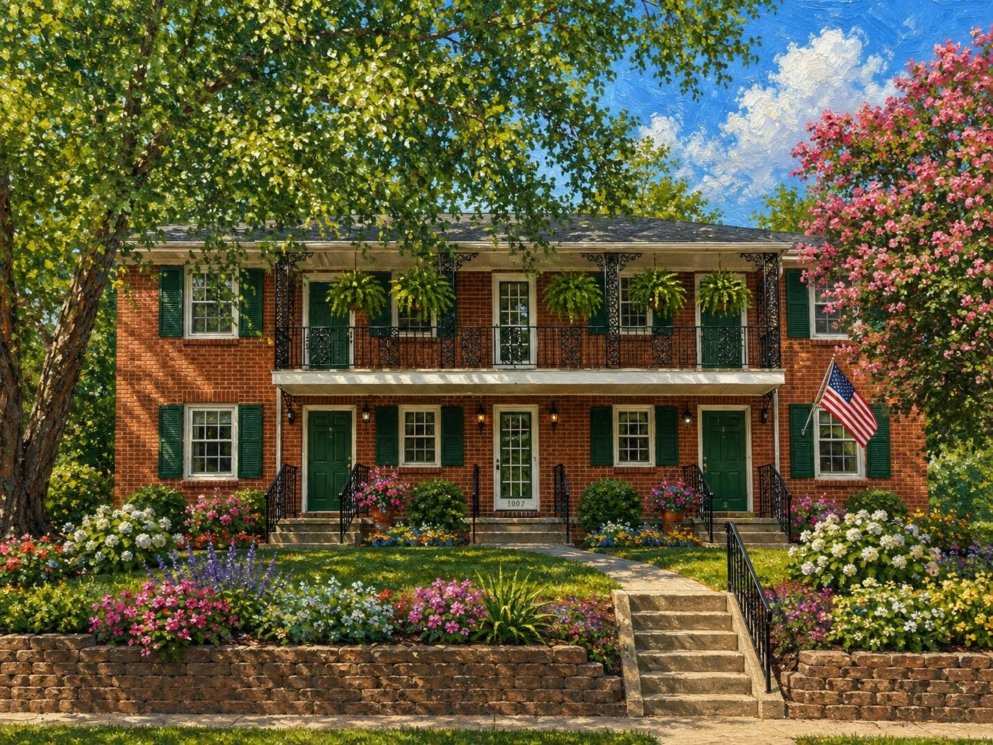A two-story brick house with green shutters and doors, decorated with hanging plants, surrounded by colorful flowers, and an American flag on the right side.