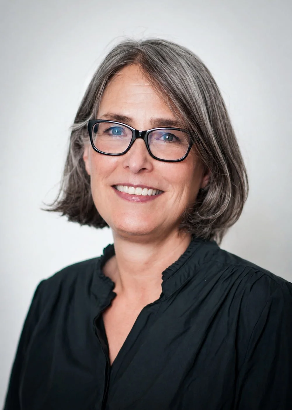 Headshot of Anne Hartman, couples therapist in Brixton and South London, smiling to camera