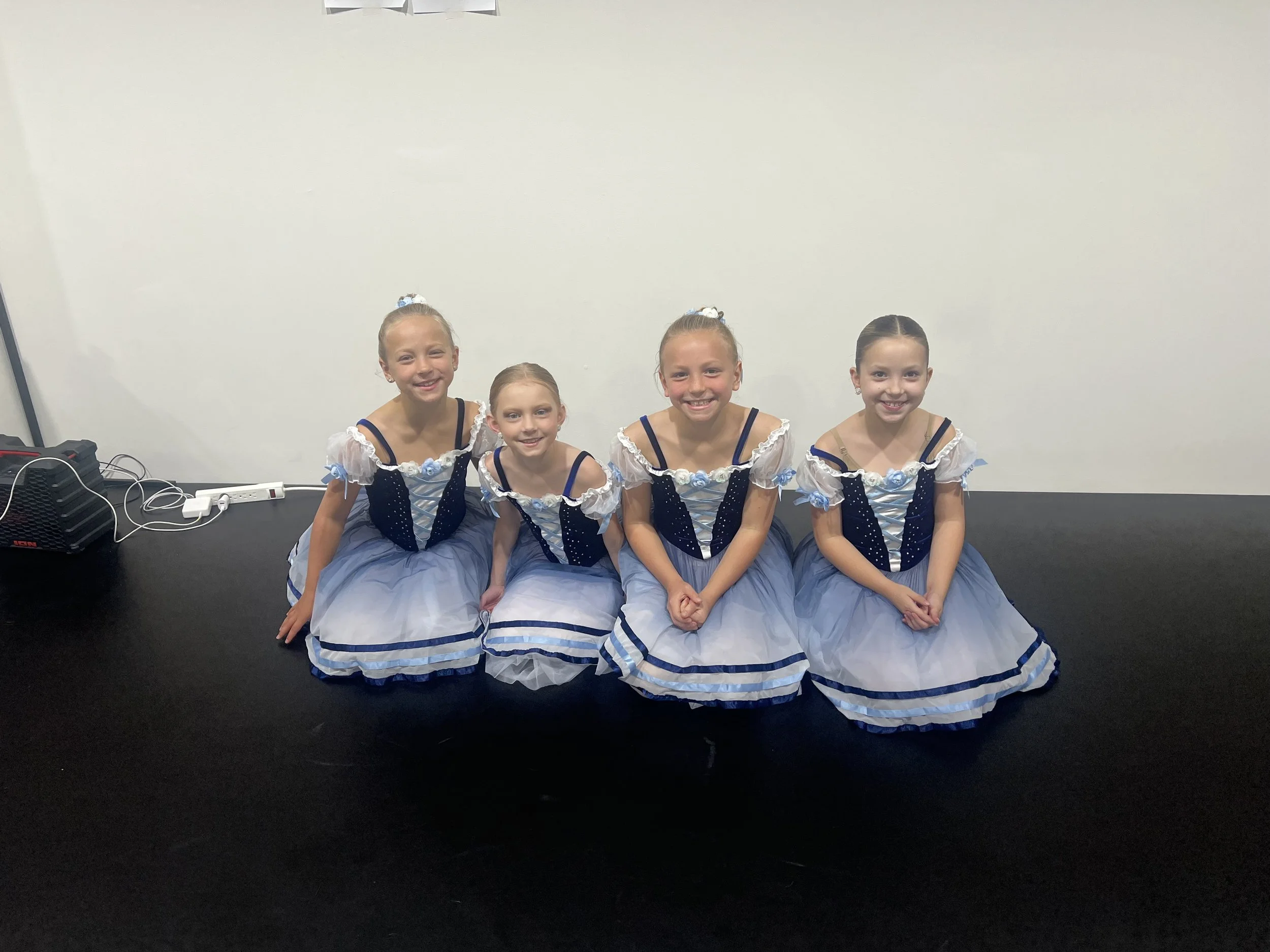 Four happy, smiling dance students