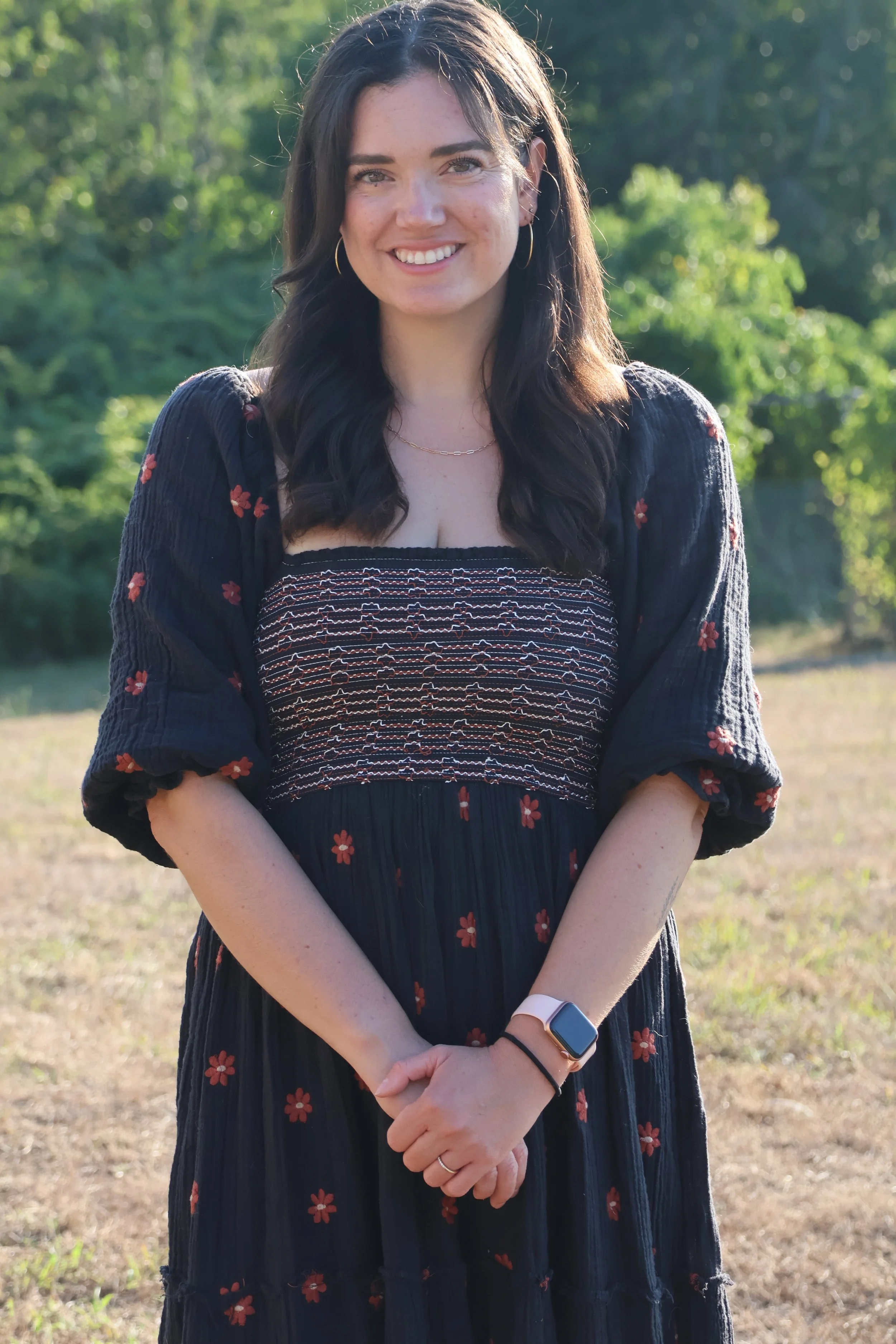 Kenda Price, LCSW, smiling outdoors