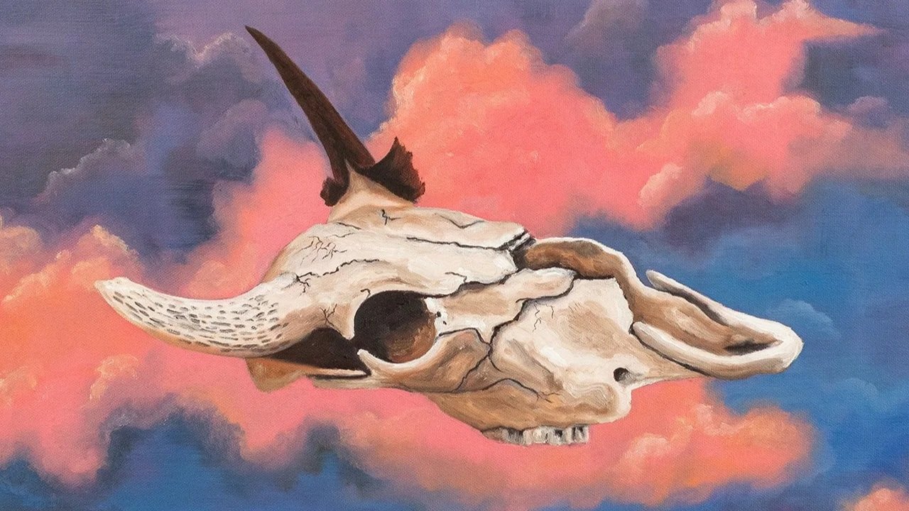A painting of a animal skull with a horn, set against a colorful pink and blue sky background.