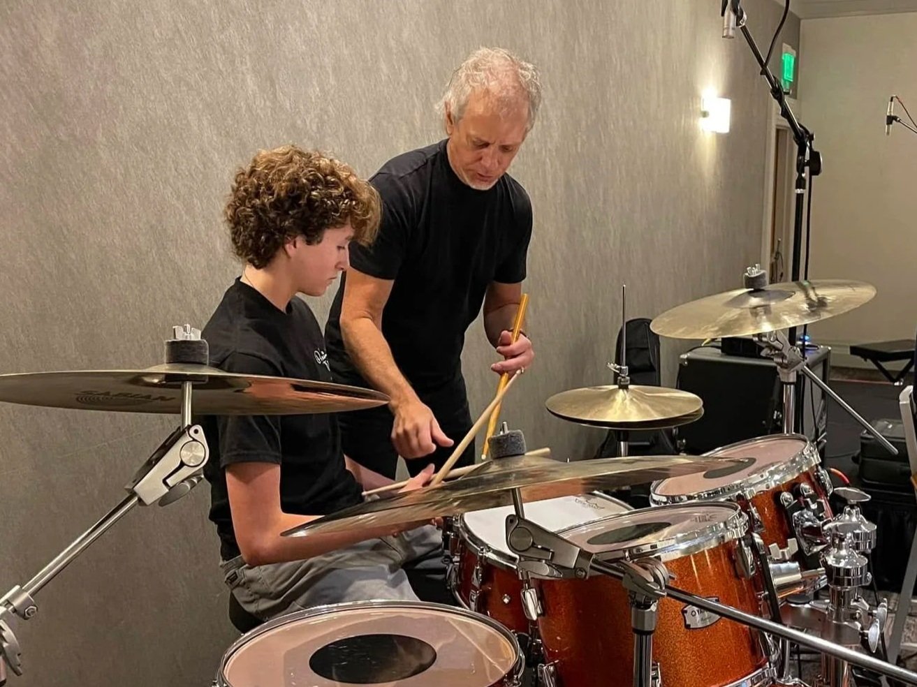 Drummer Dave Weckl teaches a young student at Drum Fantasy Camp.