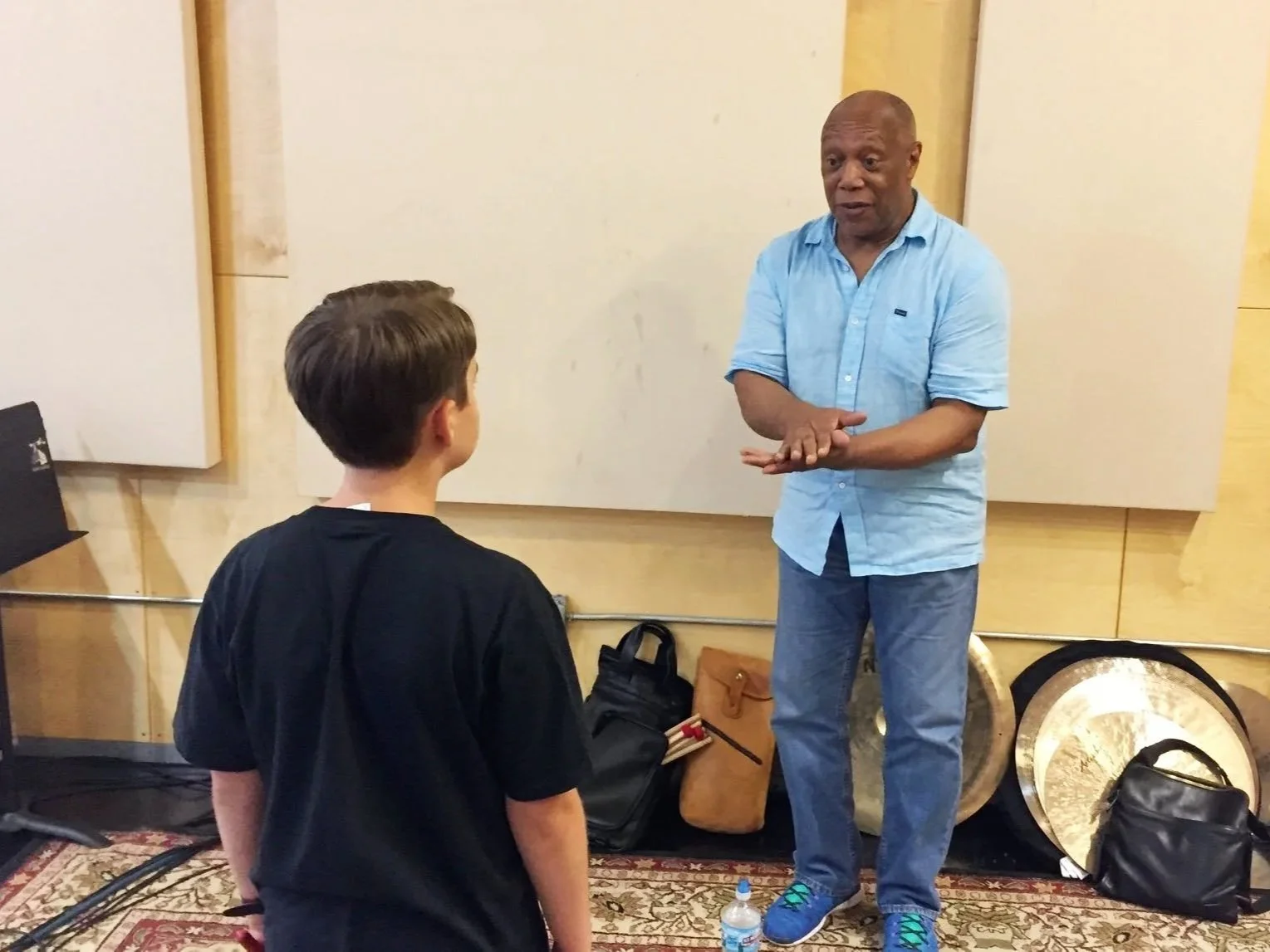Billy Cobham teaching a young boy at Drum Fantasy Camp.