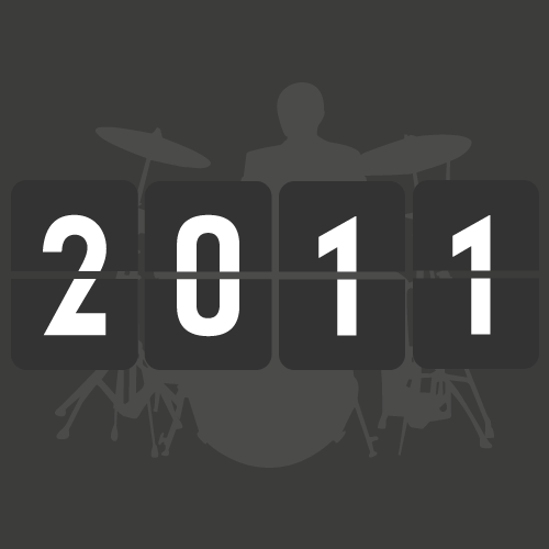 Digital countdown display showing 2011 with a faded drum set in the background