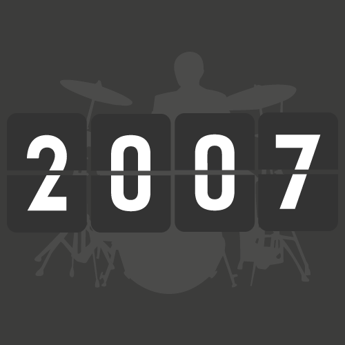 A digital flip clock displaying the time 2007, with a silhouette of a person playing drums in the background.