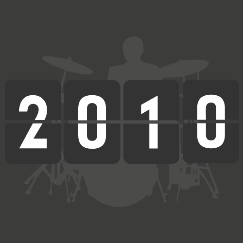 A digital flip clock displaying the year 2010 with a silhouette of a drummer and drum set in the background.
