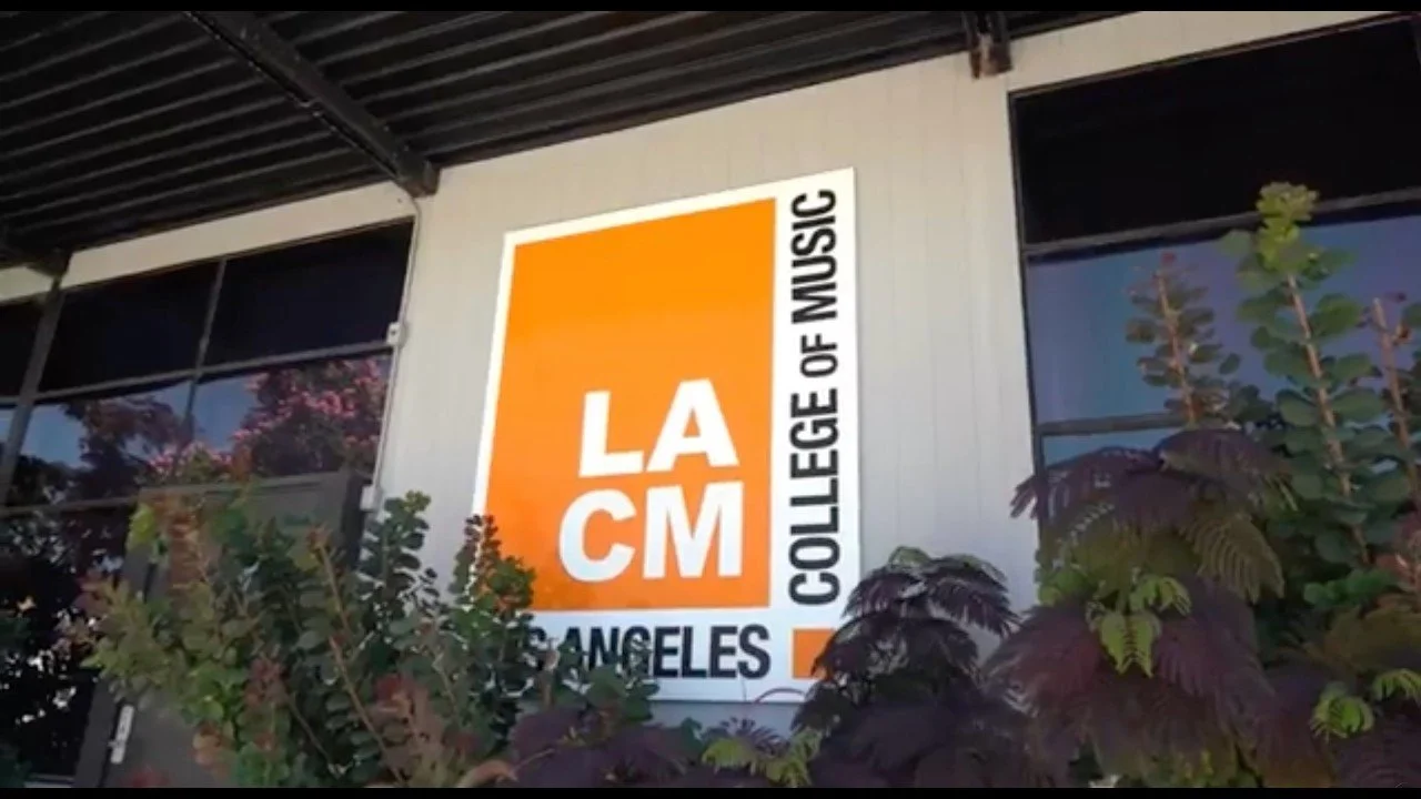 Sign for the Los Angeles College of Music with an orange and white background during Drum Fantasy Camp.