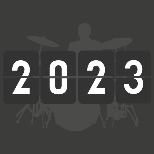 A digital flip clock displaying the year 2023 with a silhouette of a drummer playing a drum set in the background.