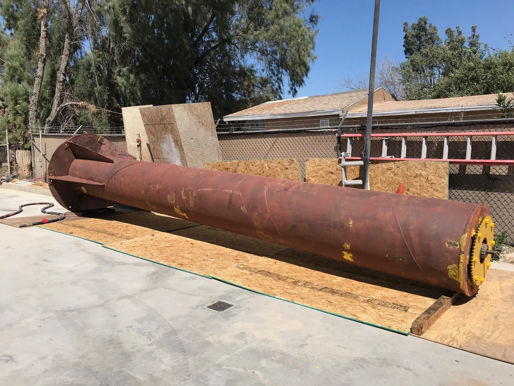 Rusted steel crane mast in the shop yard before blasting